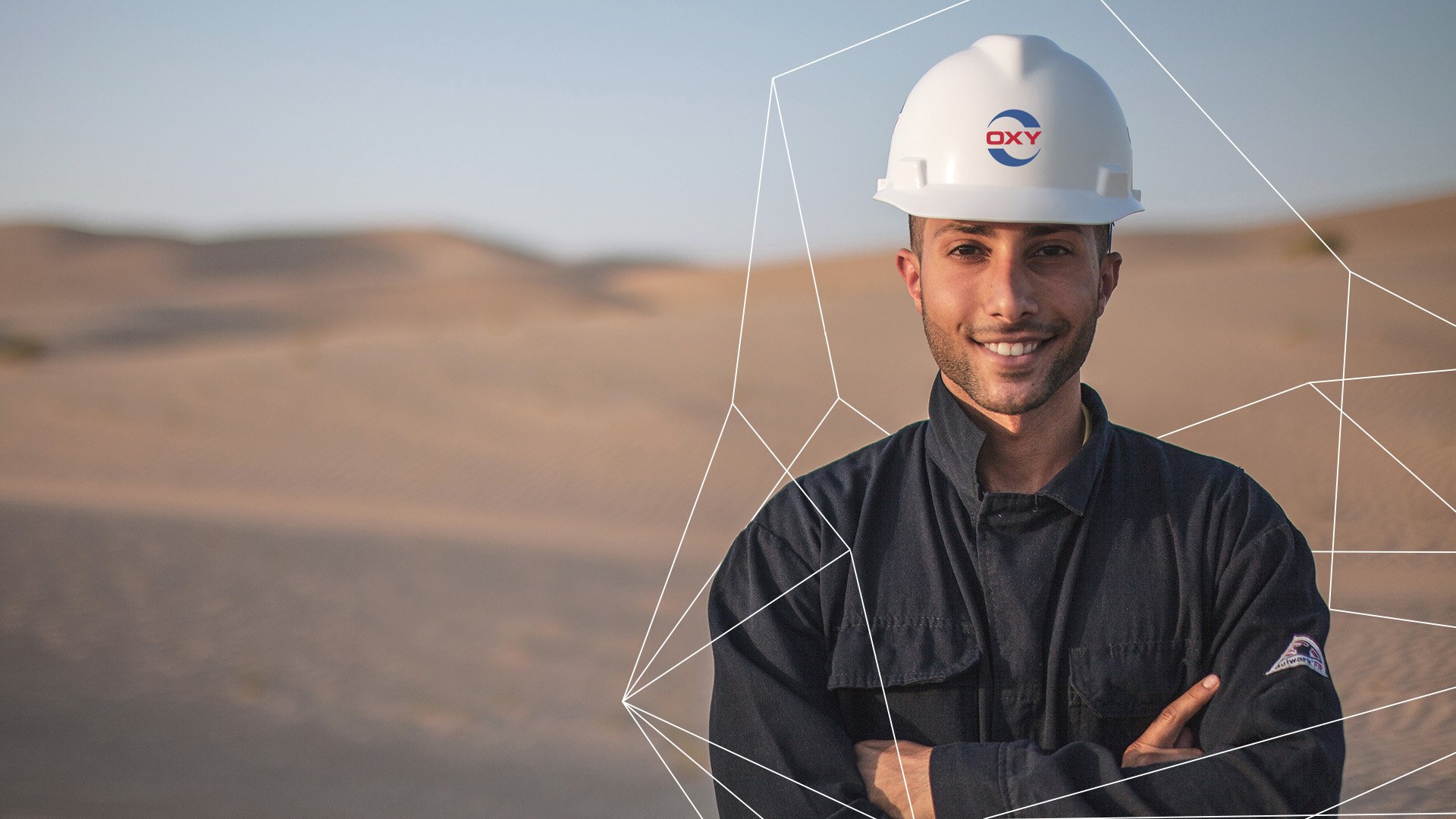 Male Oxy employee wearing hardhat in UAE desert 