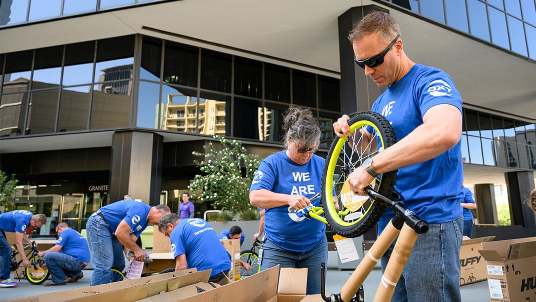 Denver Oxy employees assembling Wish For Wheels bikes