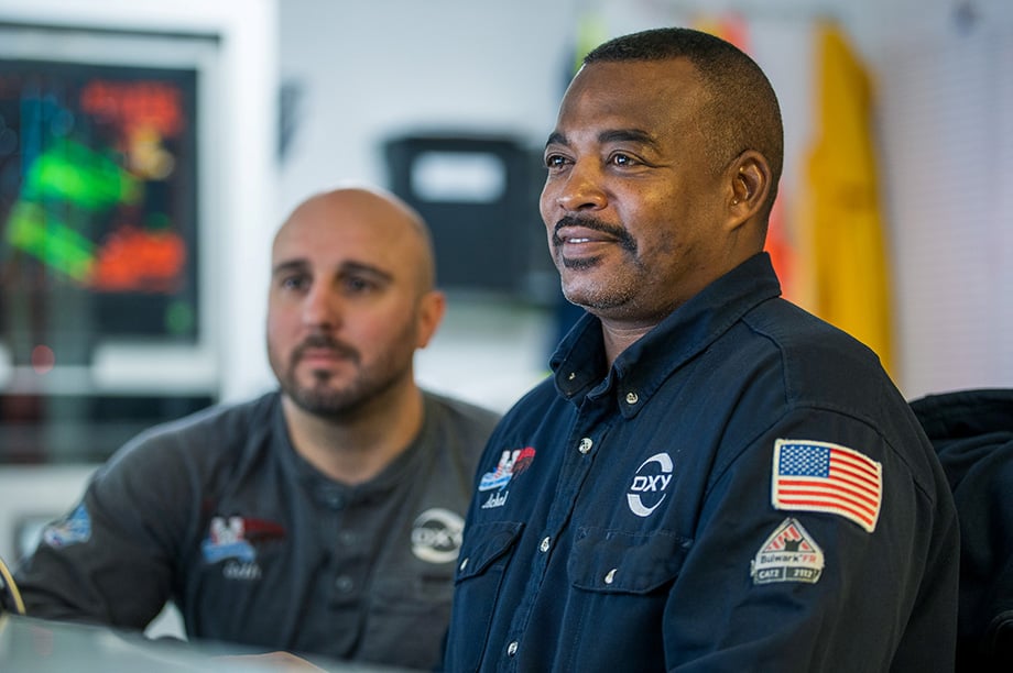 Two male Oxy employees working on site.