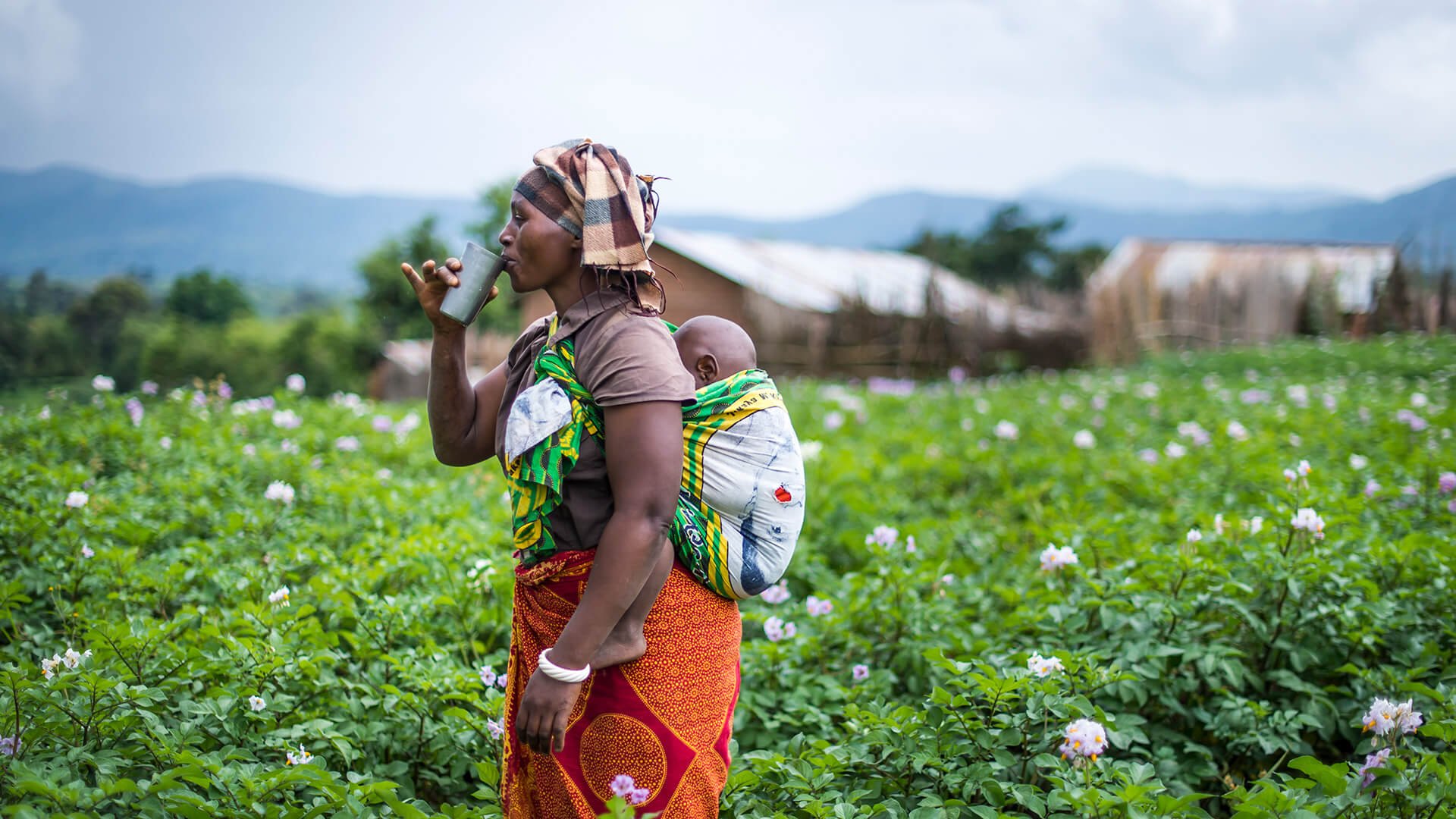 Woman carrying baby on back in Tanzania