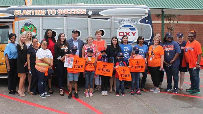 Students and employees standing in front of Oxy literacy bus 