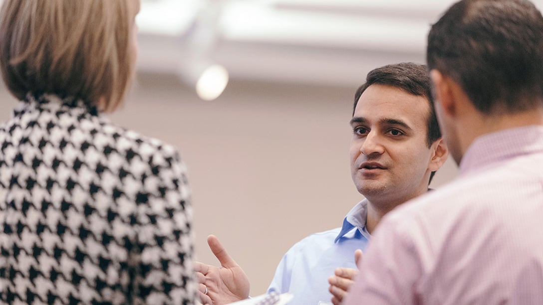 Male Oxy employee speaking to colleagues