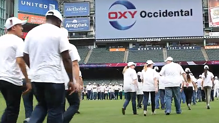 Oxy employees walking onto Minute Maid Field